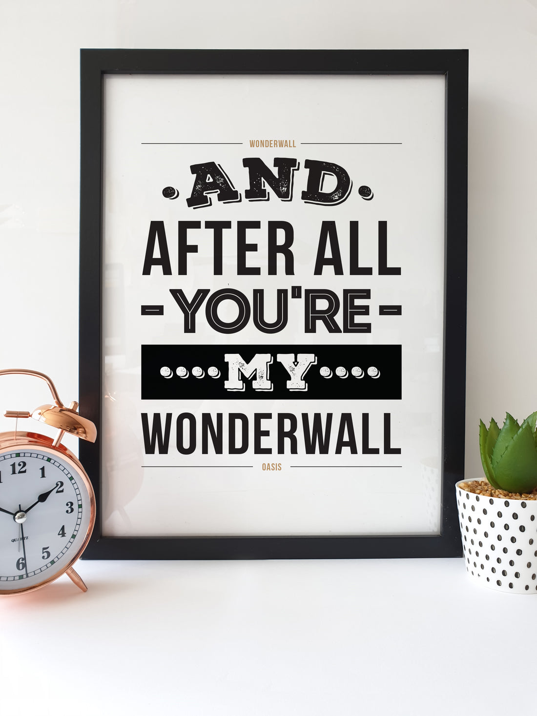 Oasis "Wonderwall" Lyrics Print by Local Lingo, featuring the iconic line 'And after all, you're my wonderwall' with black and white design in a black frame.