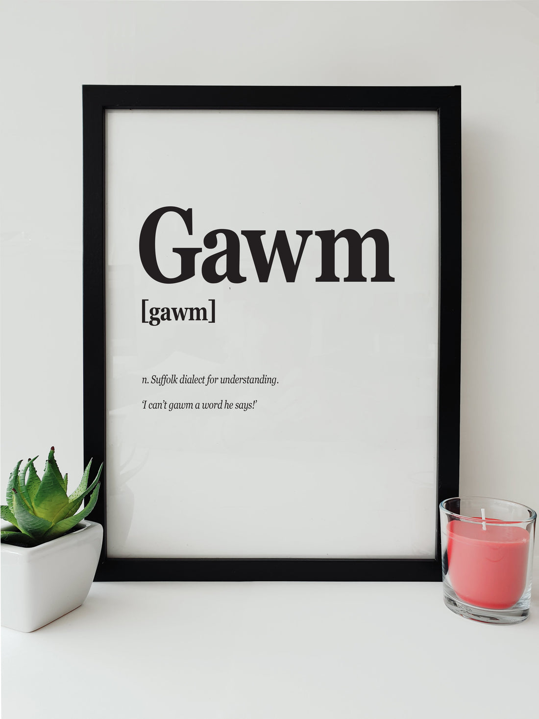 Black and white print displaying the word 'Gawm', a Suffolk dialect term for understanding, alongside the phrase 'I can’t gawm a word he says!' in a stylish font. designed by local lingo