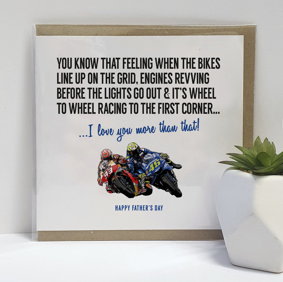 Father's Day greeting card by Local Lingo featuring a hand-drawn illustration of MotoGP legends Valentino Rossi and Marc Marquez racing to the first corner, with the text "I love you more than that!", designed on high-quality card stock.