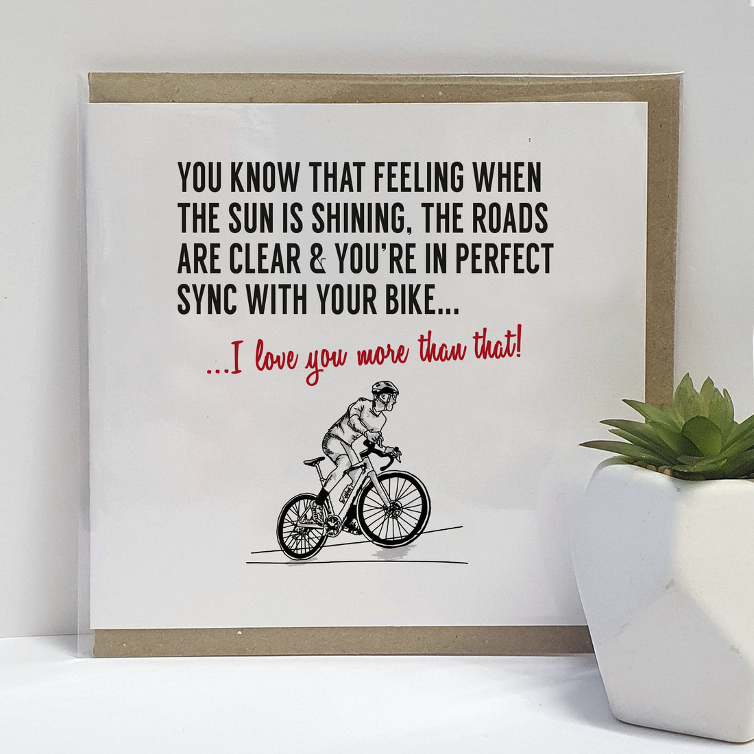 Greeting card featuring a black and white illustration of a cyclist on a clear day, with the text 'You know that feeling when the sun is shining, the roads are clear & you're in perfect sync with your bike... I hope your day is as good as that!' designed by local lingo