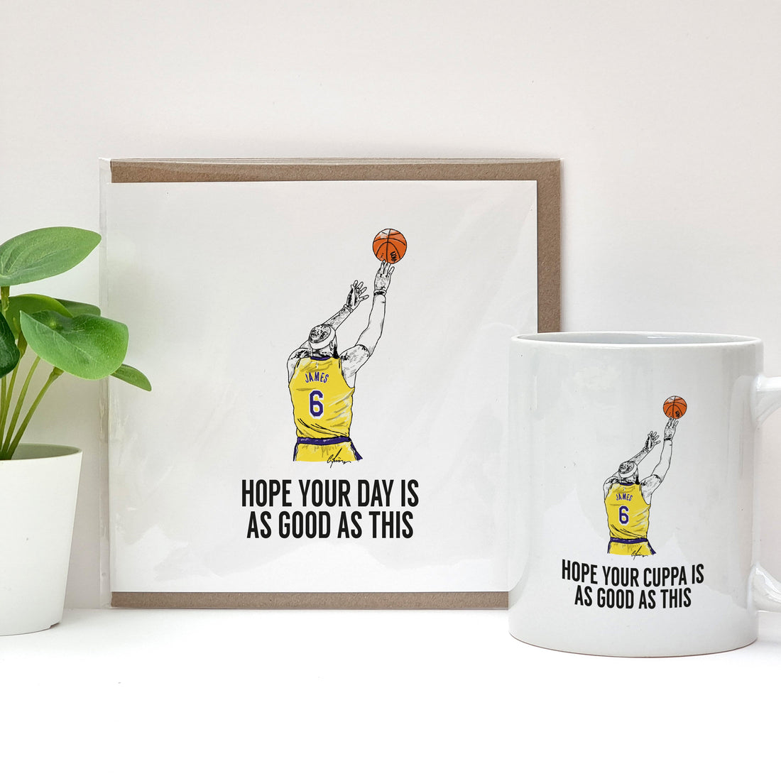 LEBRON JAMES RECORD BREAKING MOMENT TO BECOME THE BASKETBALL NBA GOAT WITH A FADEAWAY JUMPER SHOT ON ALA LAKERS MERCH COFFEE CUP AND BIRTHDAY CARD DESIGNED BY A TOWN CALLED HOME