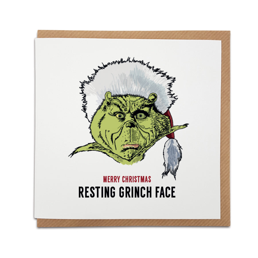 A handmade The Grinch movie themed Christmas Card. A unique card, perfect for fans of this iconic film.  Card reads: Merry Christmas  (illustration of the Grinch character wearing a Santa hat) Resting Grinch face.