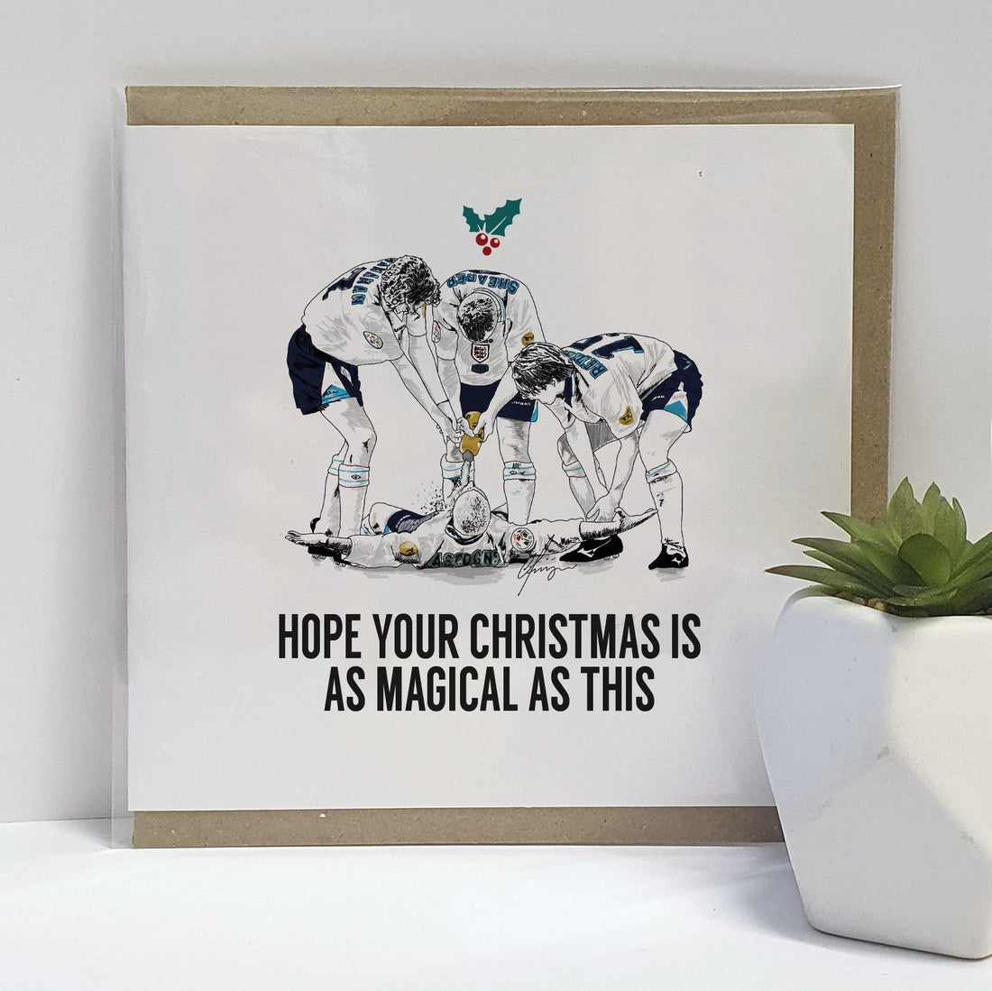 Euro 96 celebratory Christmas card.  Card reads:  I hope your Christmas is as magical as this. Featuring an illustration of the England  football team celebrating Paul Gascoigne's goal with the famous dentist chair).