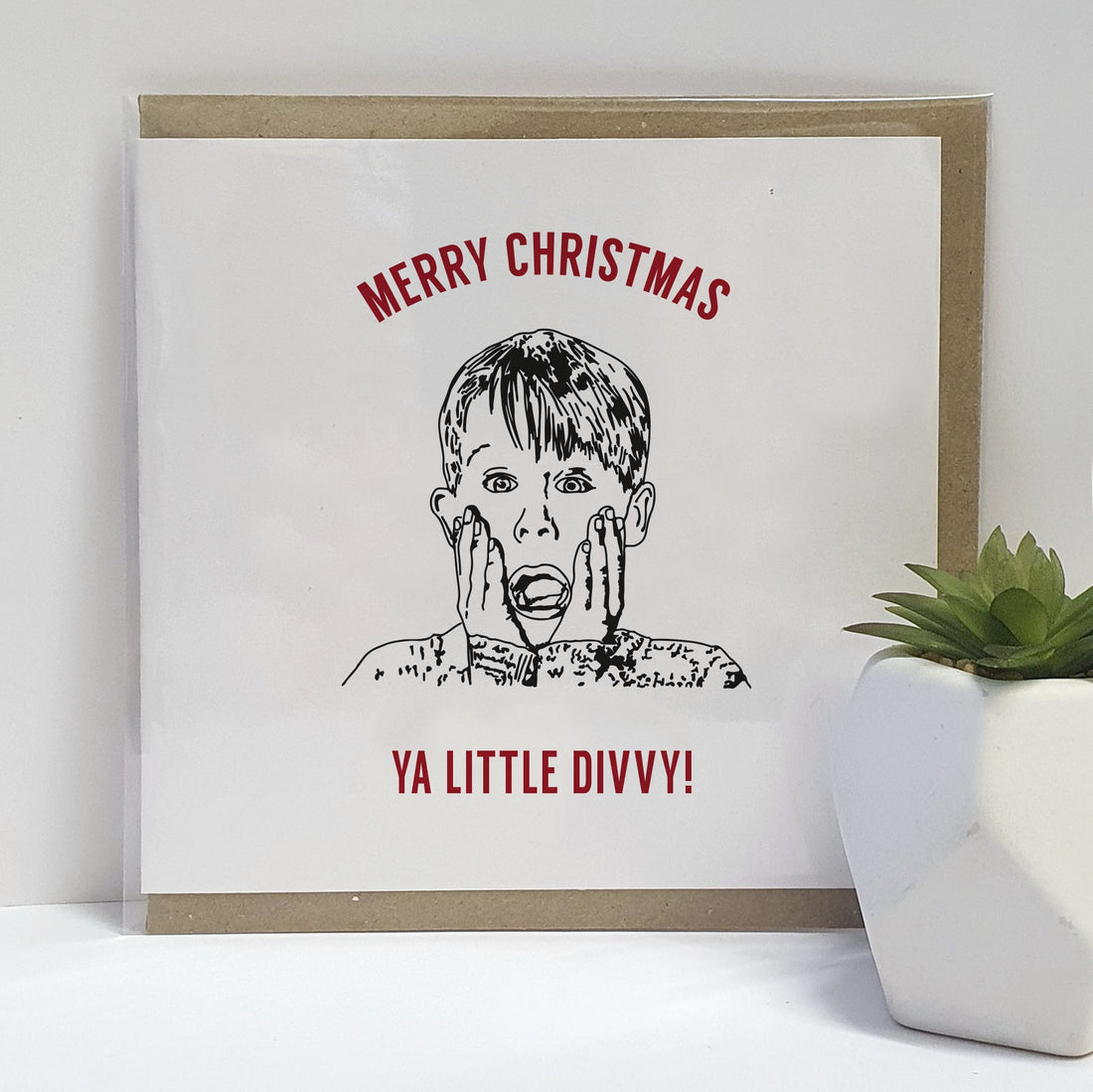 A Scouse twist on a Home Alone movie themed Christmas Card. A unique card, perfect for those fans of this iconic film (who happen to be from Liverpool).  Card reads: Merry Christmas Ya Little Divvy (illustration of Kevin McCallister). Scouse dialect.